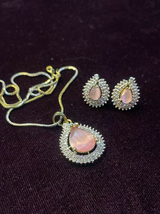 Noor Bilal – pink stone pendant set with matching teardrop earrings and shimmering accents.
