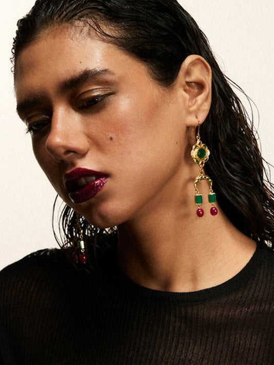 Jugnu by Hussain Rehar Verdant Drops cascading U-shaped earrings with green gemstones, cherry-red beads, and gold-toned accents, bold elegant statement accessory.