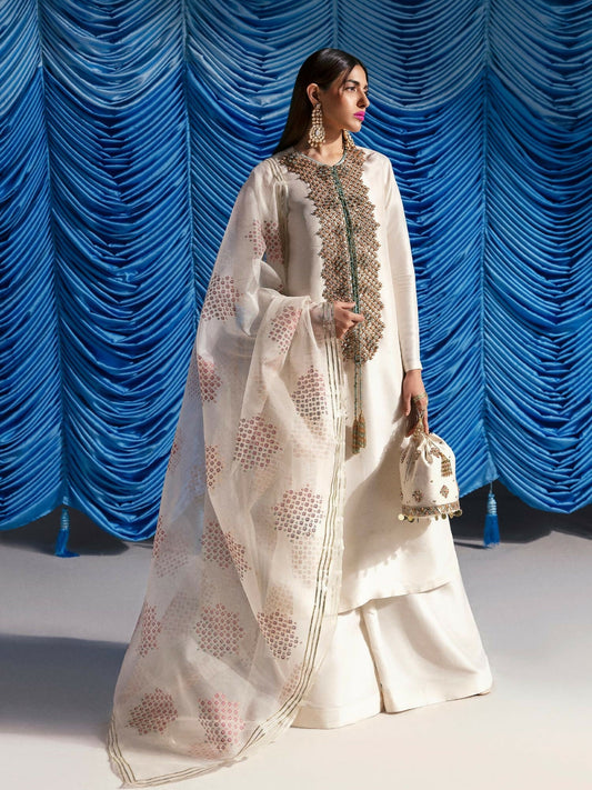 Hussain Rehar stitched 3-piece suit featuring an ivory raw silk shirt with 3D embellished neckline in sequins and cutdana, paired with raw silk palazzo pants and screen-printed organza dupatta.