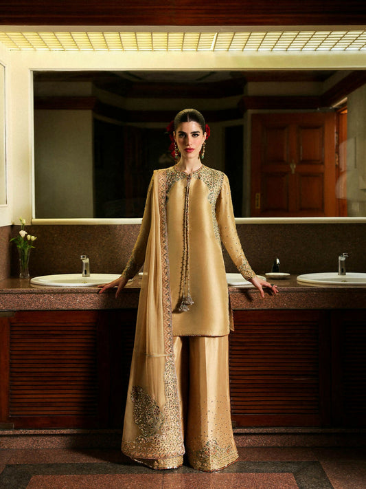 Hussain Rehar stitched 3-piece suit featuring gold raw silk embroidered shirt with cutdana and sequin handwork, chiffon dupatta with rust trims and satin patchwork, and flared raw silk pants with embroidered chanderi silk accents.