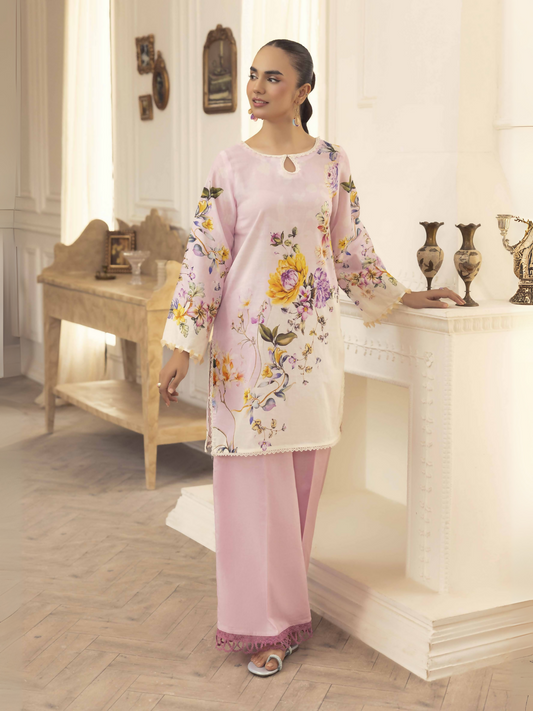 Woman wearing a soft peach-pink unstitched 2 piece lawn suit with light printed shirt and slightly darker plain trouser.