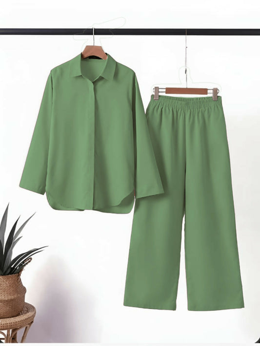 Plain stitched 2-piece cotton co-ord set with long-sleeved collared shirt and wide-legged elastic waist trouser, available in multiple colors by HU Studios.