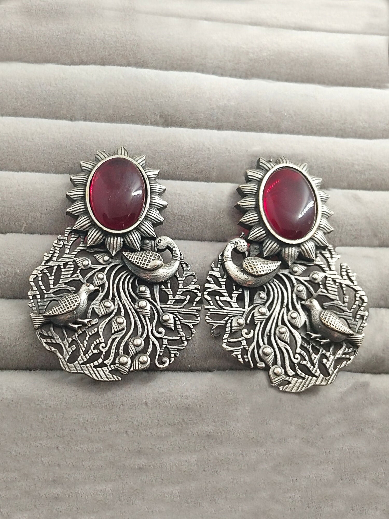 H&A Jewellery silver peacock motif earrings with red stone and sunburst design