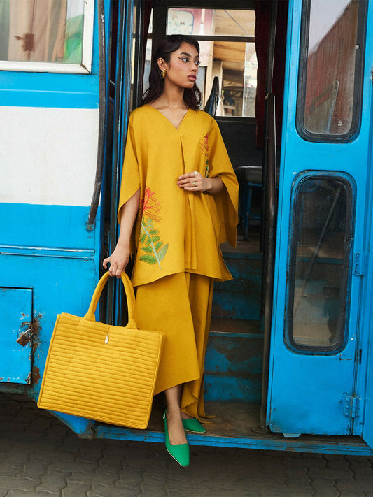 Girl wearing cotton mustard A-line shirt with exotic flower embroidery and matching A-line skirt, stitched 2-piece suit
