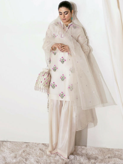 Hussain Rehar ivory raw silk hand-embellished shirt with matching embellished shalwar and sequin-sprayed organza dupatta.