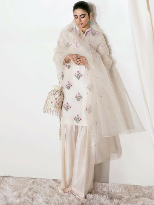 Hussain Rehar ivory raw silk hand-embellished shirt with matching embellished shalwar and sequin-sprayed organza dupatta.