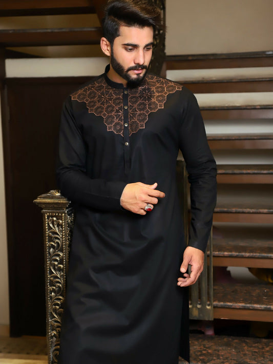 Premium unstitched men’s black kameez shalwar from Fabrich'25 Bespoke Collection, tailored in fine 100% cotton with intricate chest embroidery and signature design accents  includes designer buttons and elegant brand packaging.