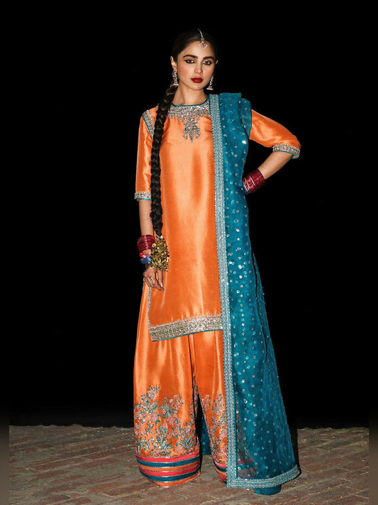 Hussain Rehar stitched 3-piece suit featuring a raw silk embellished short shirt, raw silk embroidered shalwar, and teal blue organza dupatta with sequin spray and embellished border