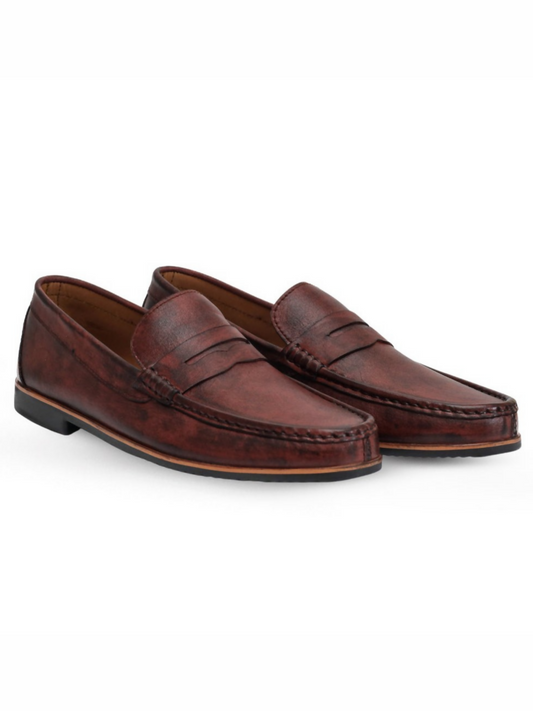 Elegant red leather loafers featuring a penny slot and smooth silhouette, ideal for smart-casual and formal looks.