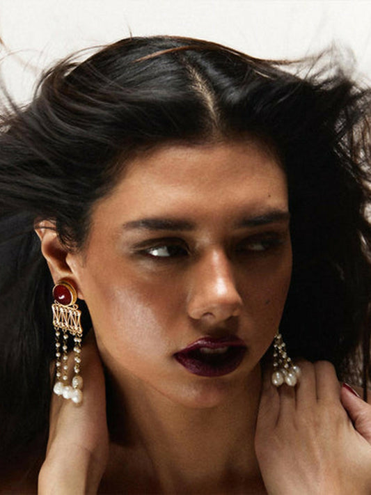 Jugnu by Hussain Rehar Amber Filigree earrings with intricate gold filigree design, baltic amber centerpiece, and delicate pearl strands, regal elegant accessory.