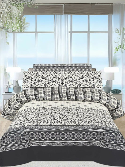 A white king-size bedsheet with a bold black floral design, paired with matching pillow covers, neatly spread on a bed.