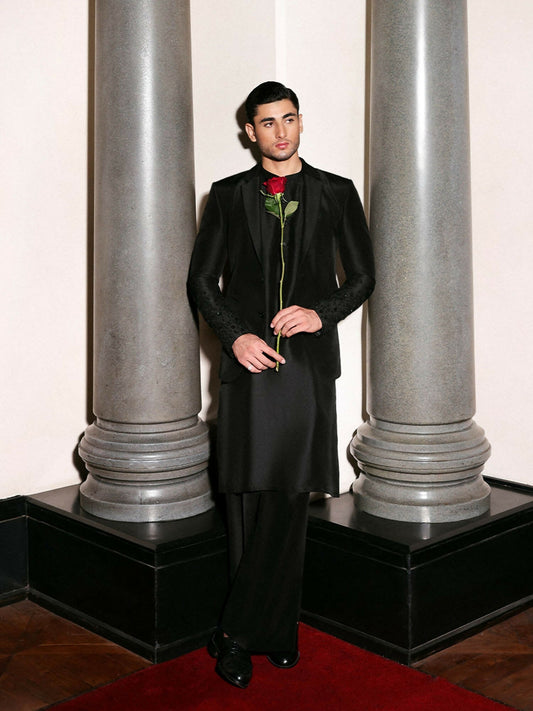 Hussain Rehar black raw silk three-piece ensemble with embroidered and hand-embellished blazer, band-collar kurta, and straight trousers.