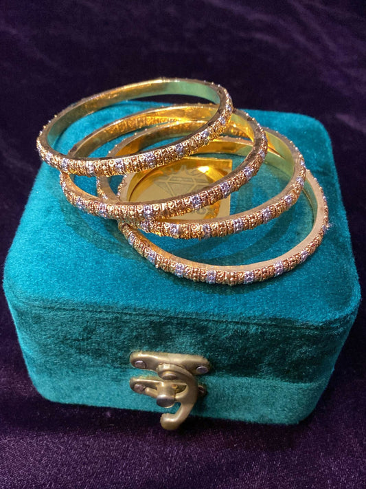 Noor Bilal gold plated bangles with elegant polished design.
