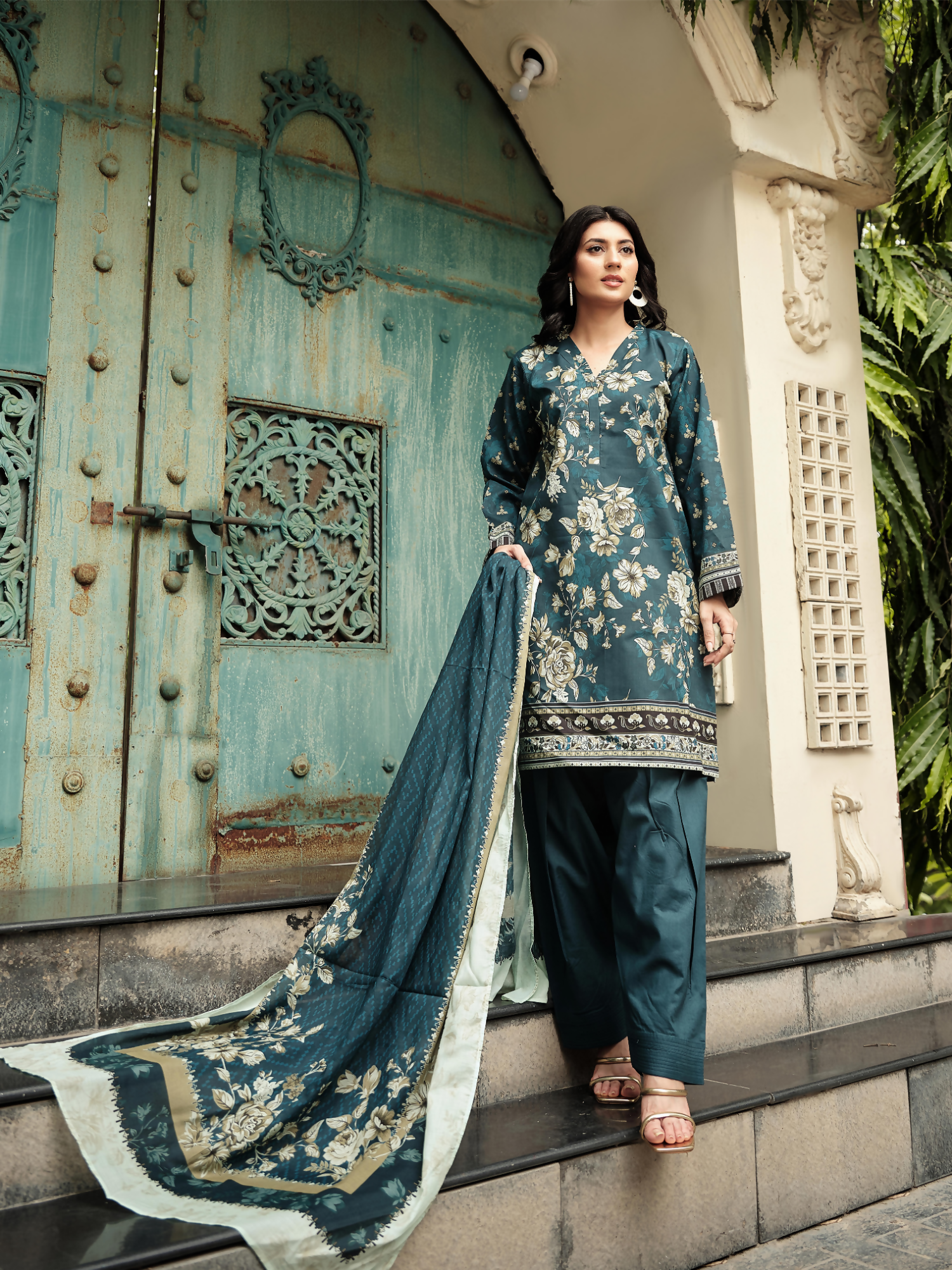 Unstitched 3-piece suit with a dark teal floral printed lawn shirt, coordinating printed dupatta, and matching dyed trouser.