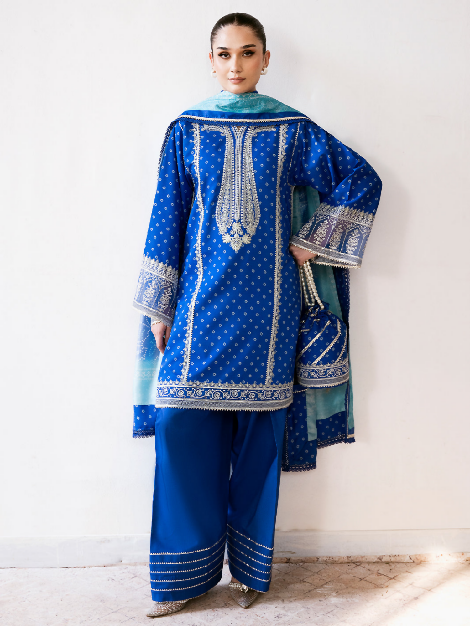 Bin Ilyas unstitched 3-piece suit with digital printed lawn front, sequin embroidered organza neckline and laces, digital printed dupatta, and dyed cotton trouser.