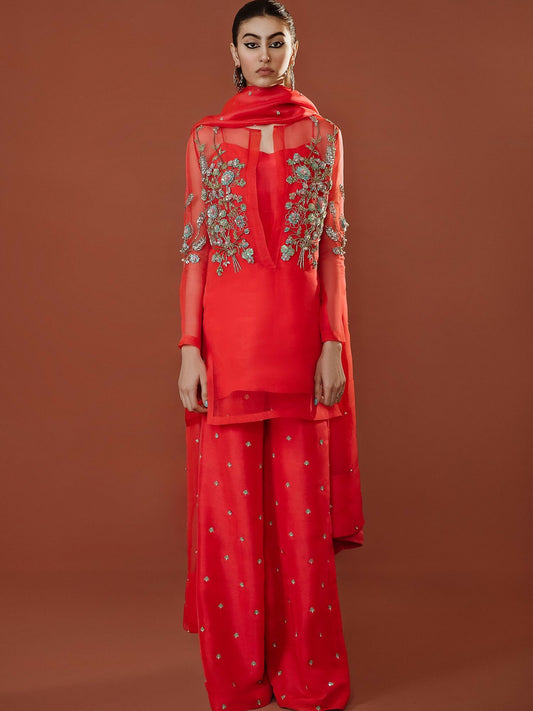Stark carrot pink organza outfit with turquoise floral sequin and pearl embellishments, palazzo pants, and hand-embellished dupatta by Hussain Rehar.
