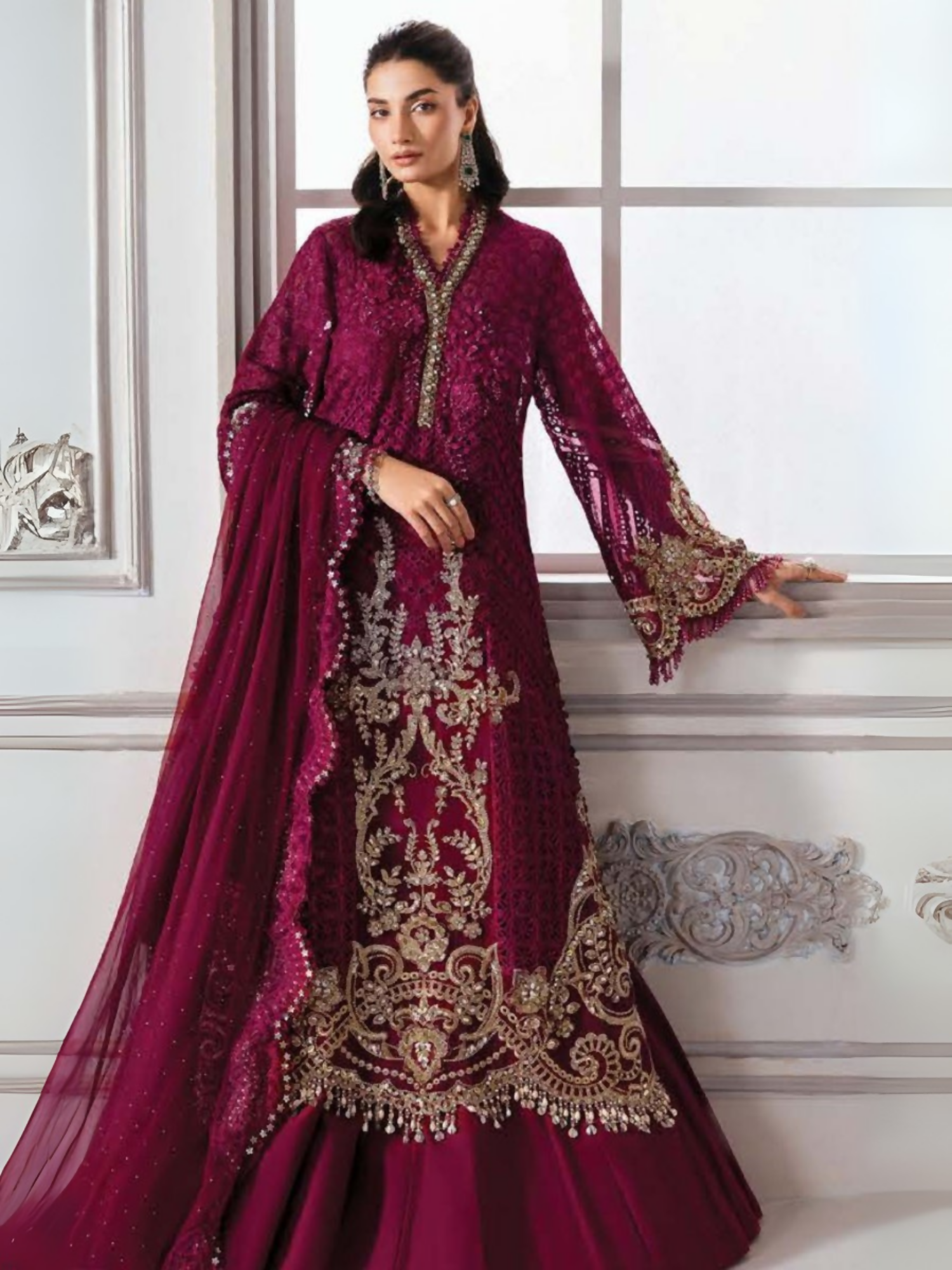 Woman wearing a 3-piece unstitched luxury chiffon suit with intricate embroidery, 3D flowers, hand embellishments, raw silk trouser, and a chiffon dupatta with diamantes.