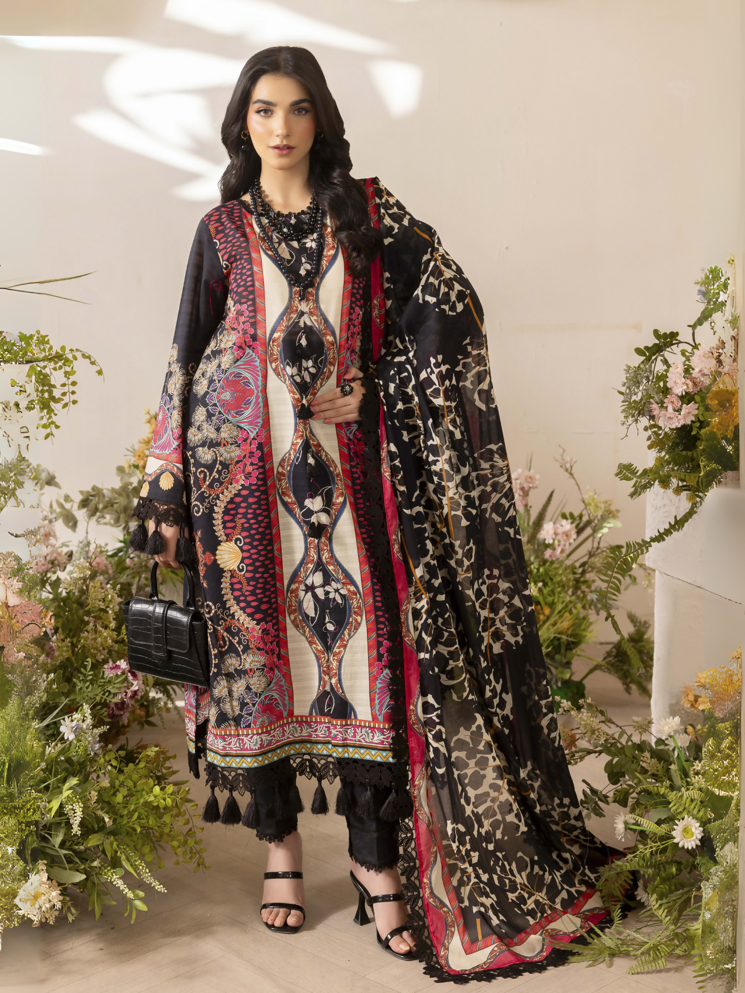 Girl standing wearing an unstitched 3-piece suit with premium digital printed slub lawn shirt, digital printed pure voile dupatta, and dyed cotton trouser, styled for summer comfort and elegance.