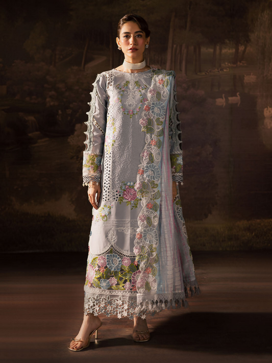 Girl standing wearing an unstitched 3-piece suit with embroidered lawn shirt front, daman, and sleeves, styled with a printed embroidery Monark dupatta and dyed Cambridge trouser with slip, ideal for graceful festive wear.