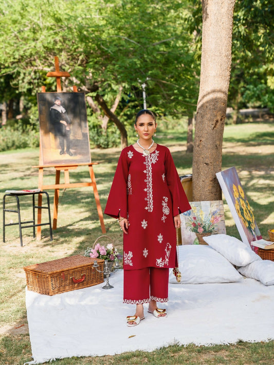 Rich red stitched two-piece suit with embroidered front and sleeves, pearl embellishments on sleeves, paired with embroidered trousers by Sehrish Kanwal.