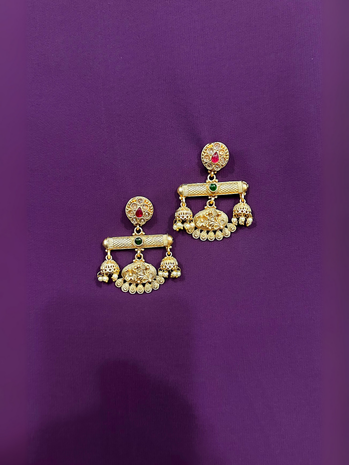 Glitter Jewellery traditional gold-toned earrings with kundan stones and pearl drop detailing.