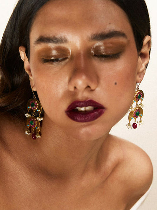 Jugnu by Hussain Rehar Golden Glow crescent-shaped earrings with emerald green, ruby red, and sapphire blue gemstones, pearl accents, and dangling teardrop detail, regal luxurious statement accessory.