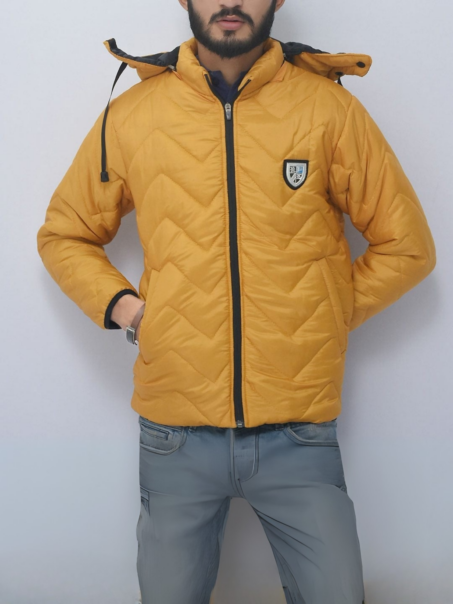 Goose down puffer jacket with 100% polyester shell, detachable hood, zigzag quilted design, and relaxed fit for winter warmth