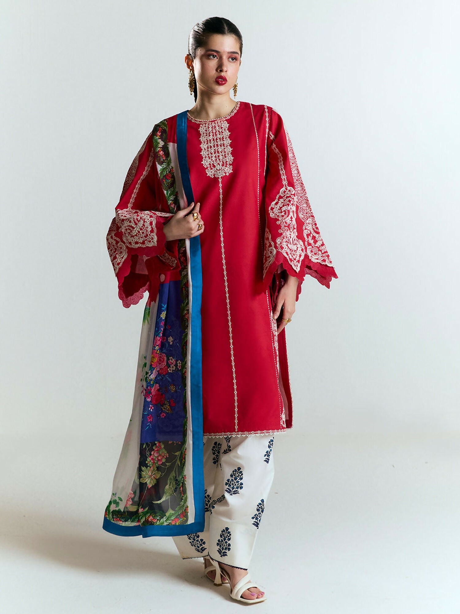 Unstitched crimson red 3-piece suit featuring monochrome dori embroidery on cotton shirt, ivory screen-printed cotton shalwar, and digitally printed silk dupatta — elegant traditional ensemble.