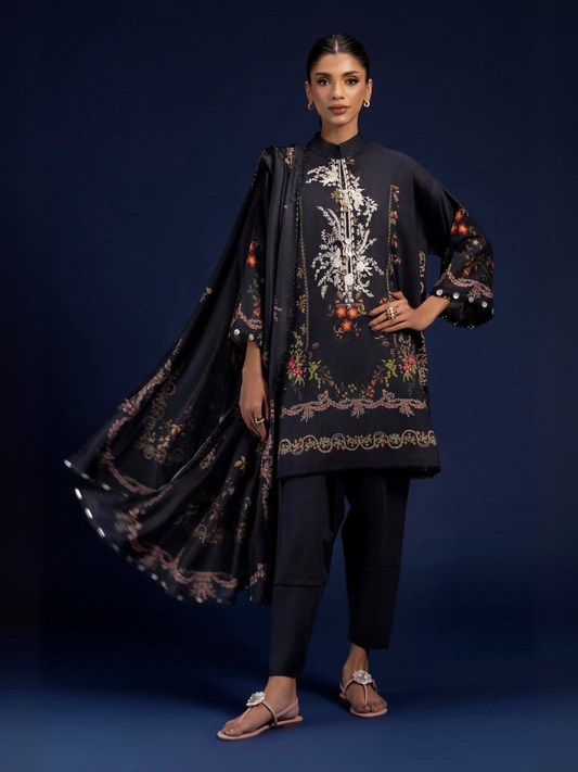 Unstitched 3-piece suit by Sana Safinaz with digitally printed lawn shirt, embroidered neckline on organza, digital printed tennis net dupatta, and dyed cambric pants.