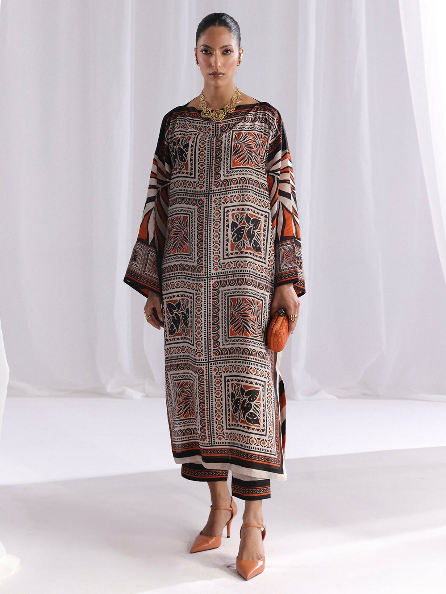 Unstitched digital printed silk 2-piece co-ord suit in orange and brown color by Bin Ilyas with matching shirt and trouser, stitched for a modern and elegant look.