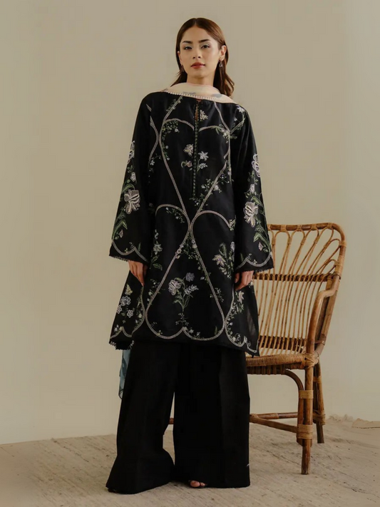 Unstitched 3-piece embroidered suit with soft lawn shirt featuring pastel and black embroidery, dyed cambric trouser, and digital printed chiffon dupatta for a modern elegant style.