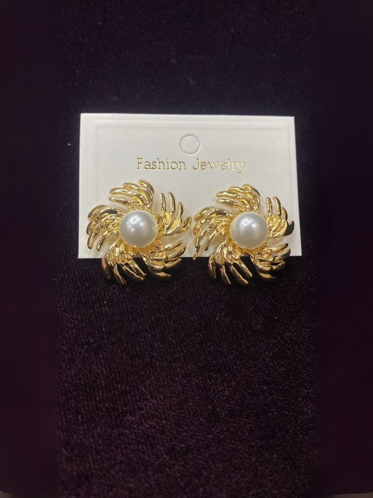 Noor Bilal golden flower studs with white pearl center, elegant and timeless jewellery accessory.