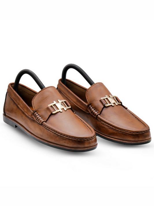 Premium leather loafers featuring a bold crest-style buckle, blending classic elegance with a modern, powerful look.
