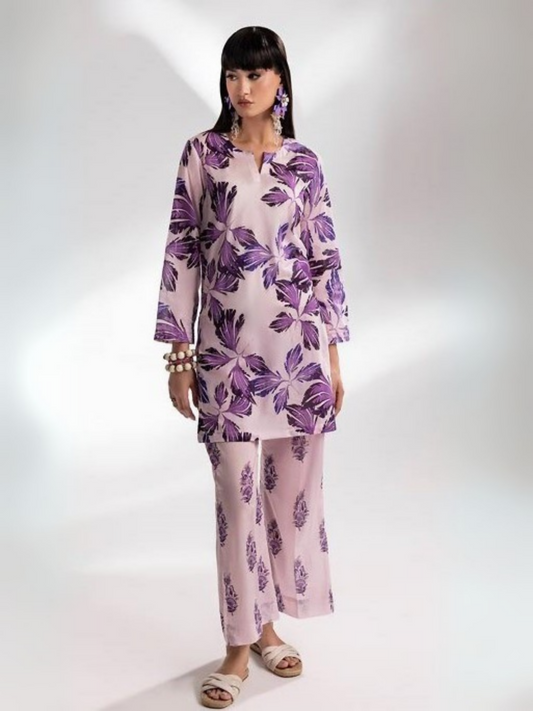 Model showcases a lilac unstitched lawn suit with striking purple botanical prints from Parizad's Vol-15 collection, paired with coordinated printed trousers.