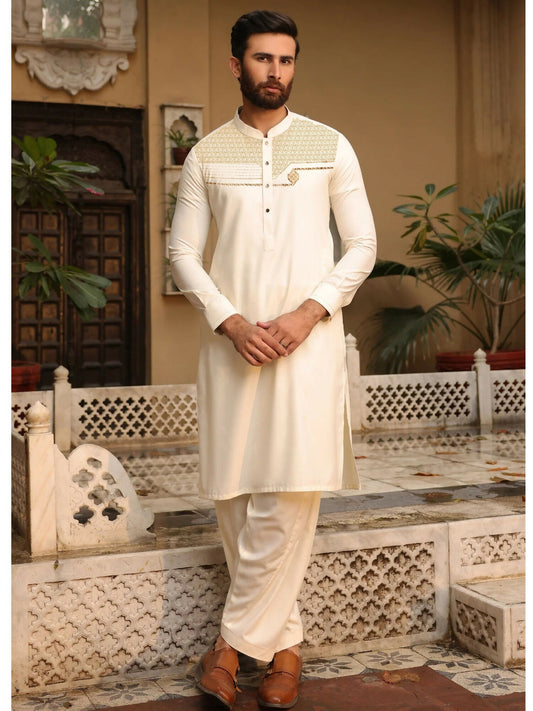 Cream-toned unstitched men’s kameez shalwar from Fabrich’s Monochrome Edit'25, featuring contrast chest embroidery in a signature pattern on soft wash n wear fabric.