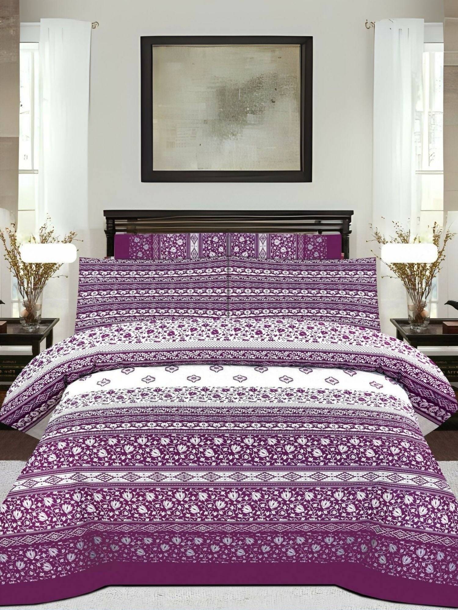 A mixed design bedsheet with magenta, purple, and white sections; white areas have magenta prints, and magenta pillow covers feature white floral patterns.
