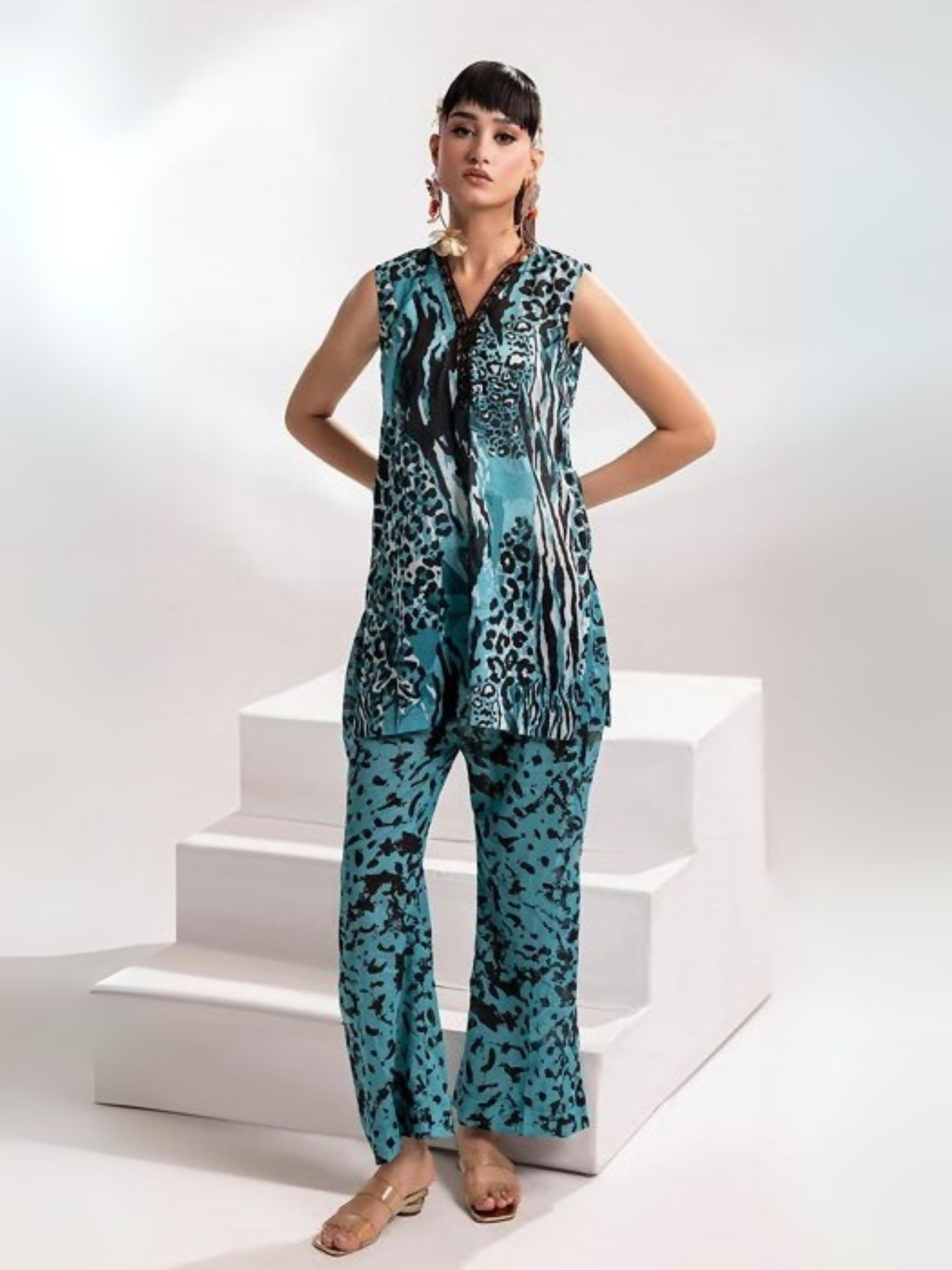 Model wearing Parizad unstitched 2-piece lawn suit (PA072503) featuring a bold aqua and black animal print on a sleeveless V-neck shirt with matching printed trousers.