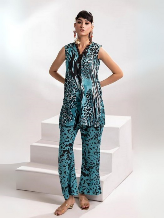 Model wearing Parizad unstitched 2-piece lawn suit (PA072503) featuring a bold aqua and black animal print on a sleeveless V-neck shirt with matching printed trousers.