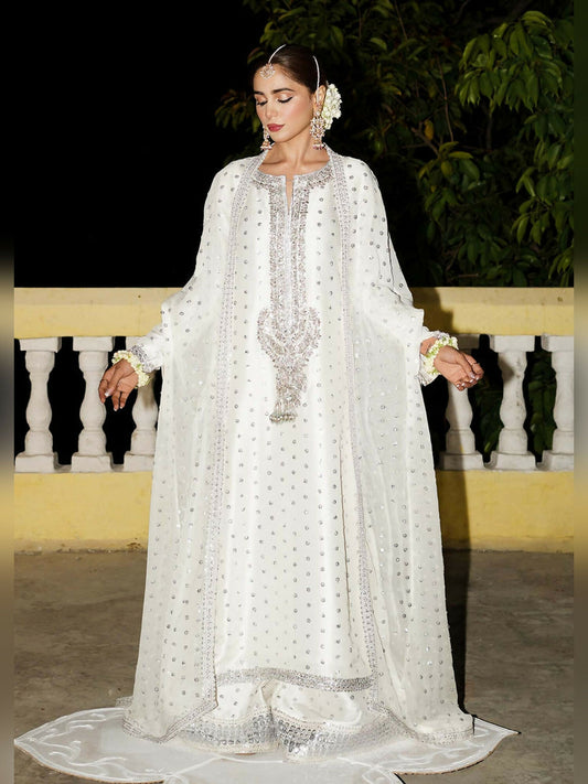 Unstitched 3-piece suit by Hussain Rehar featuring an embellished raw silk shirt with mukesh work, palazzo pants with sequined border, and chiffon jacket with dupatta.