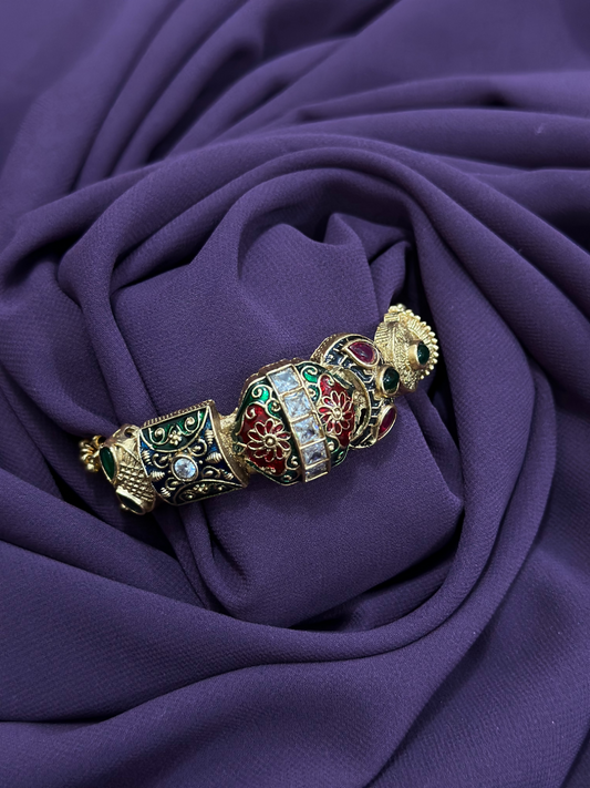 Close-up of an antique kara with multicolor stonework, floral enamel detailing, and dangling golden beads – traditional jewellery piece from Glitter Jewellery.