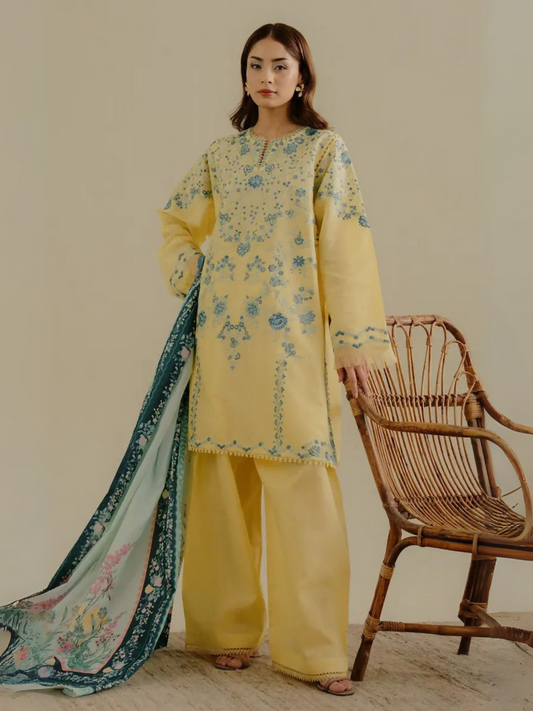 Unstitched 3-piece embroidered suit with yellow lawn shirt featuring blue floral embroidery, dyed cambric trouser, and digital printed self-jacquard dupatta for a bold, elegant look.