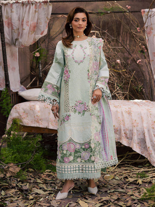Girl standing wearing an unstitched 3-piece suit with embroidered lawn shirt front, daman, and sleeves, paired with a printed embroidery Monark dupatta and dyed Cambridge trouser with slip, designed for festive elegance.
