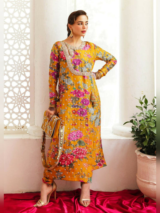 Stitched 3-piece suit by Hussain Rehar with mustard long raw silk printed angrakha-style shirt embellished with sequins and bugle beads, paired with printed chooridaar and ivory organza dupatta with kiran.
