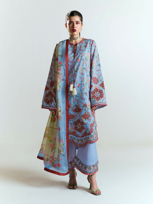 Light blue printed cotton shirt with multicolor floral embroidery, scalloped borders, and tassel ties, paired with matching embroidered culottes and a digitally printed silk dupatta in soft floral hues.