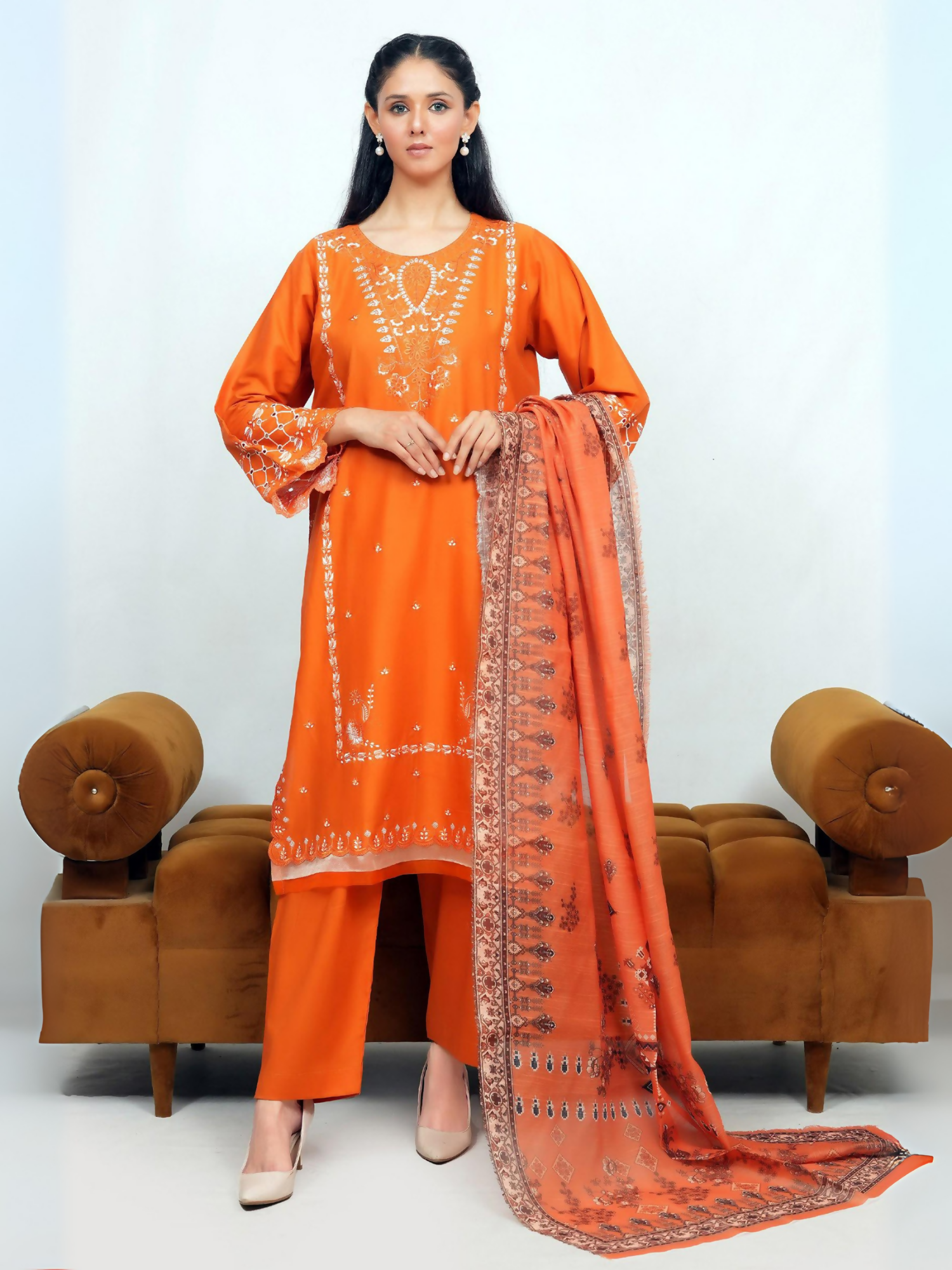 Woman wearing stitched 3-piece suit with intricate white embroidery on straight-cut shirt, full sleeves with embellished cuffs, digitally printed dupatta, and matching straight trouser.