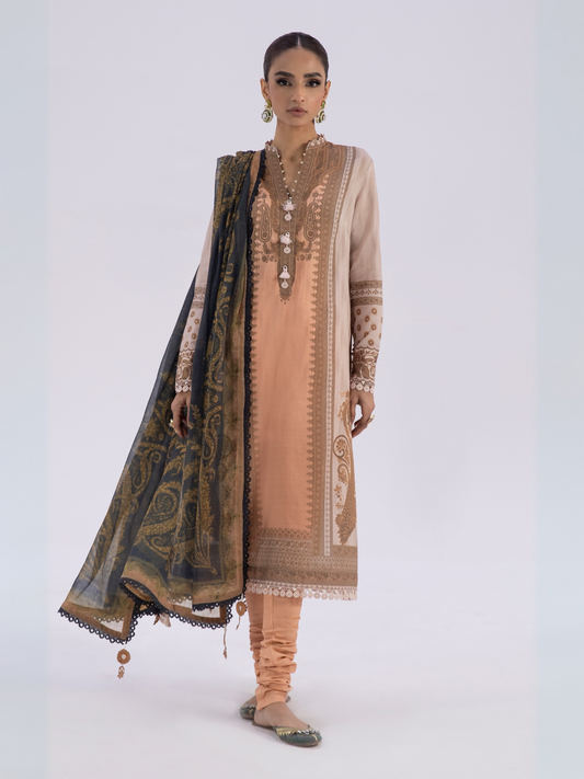 Woman wearing a light peach unstitched 3-piece lawn suit with a printed black dupatta and matching dyed cambric trouser.