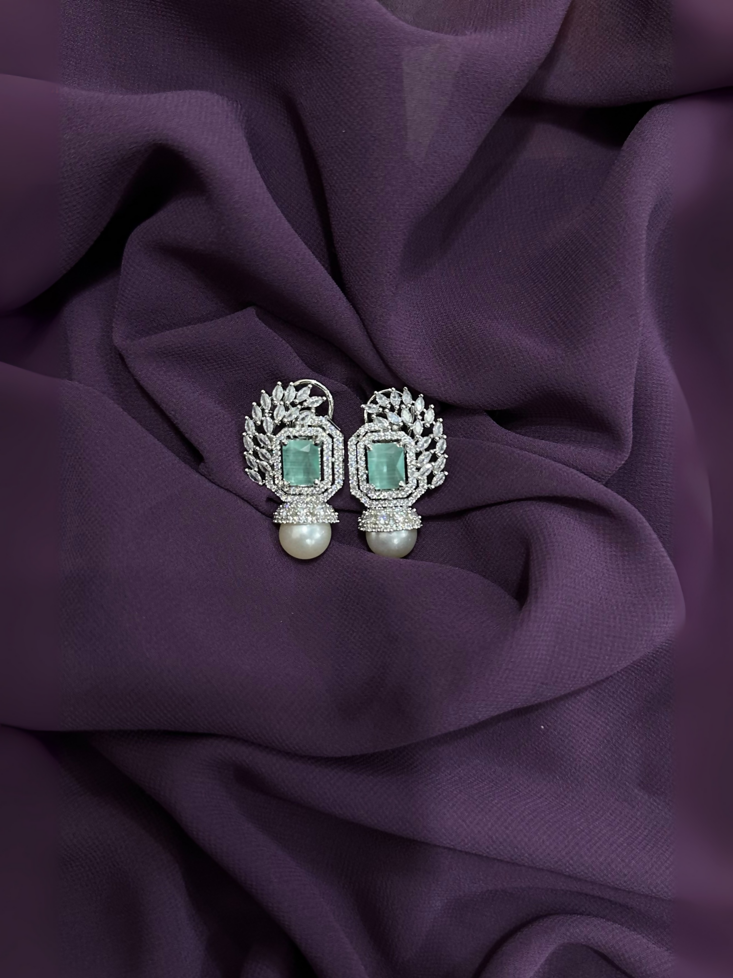 Mint green crystal and pearl drop earrings with silver-toned setting and clear crystal accents.