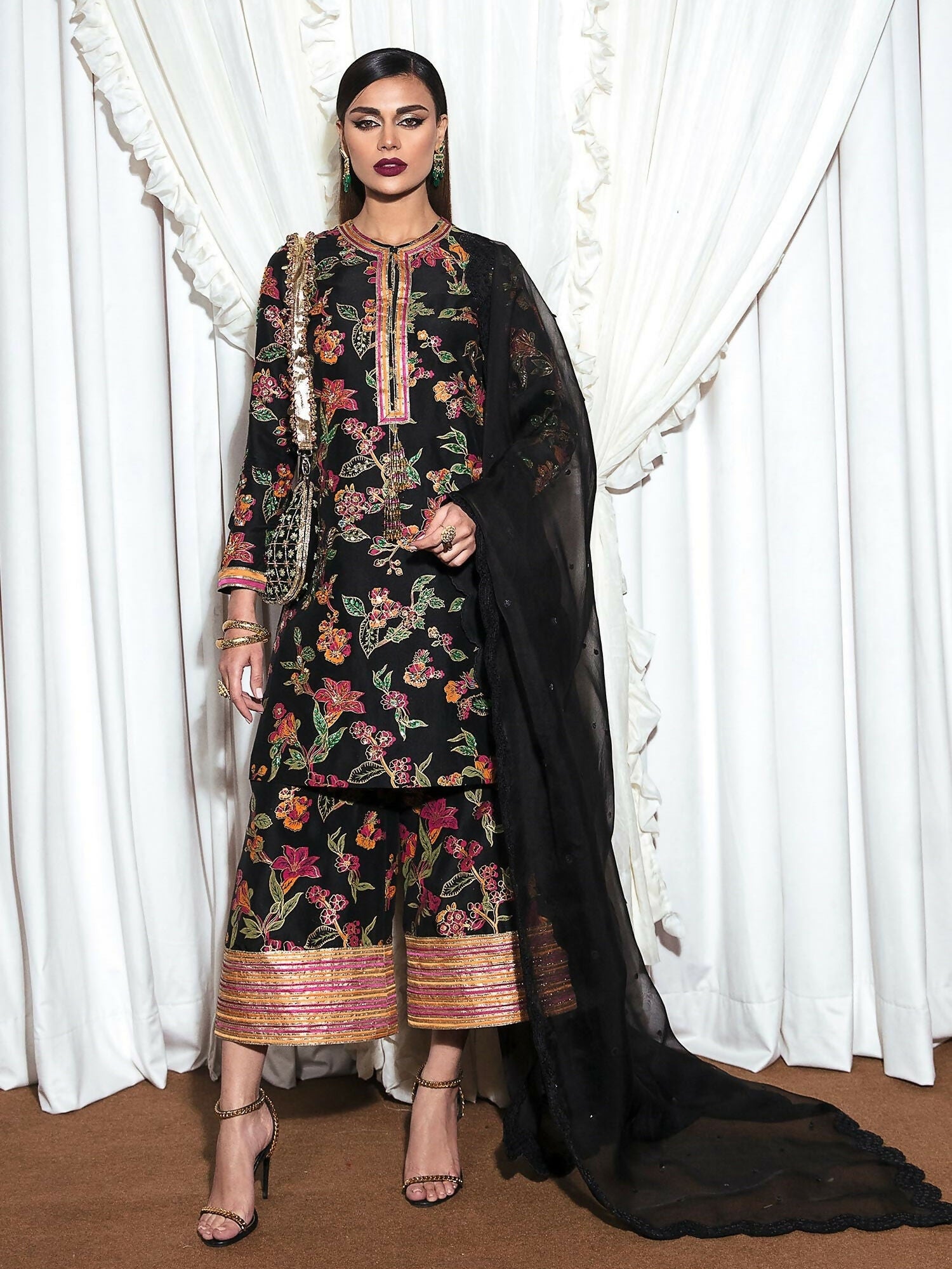 Regal raw silk stitched 3-piece suit Inky by HussainRehar featuring a block-printed shirt with gold sequins, multicolor bugle beads, and tassel neckline, paired with block-printed culottes with a bordered design and an organza dupatta sprayed with black sequins and finished with a scalloped border