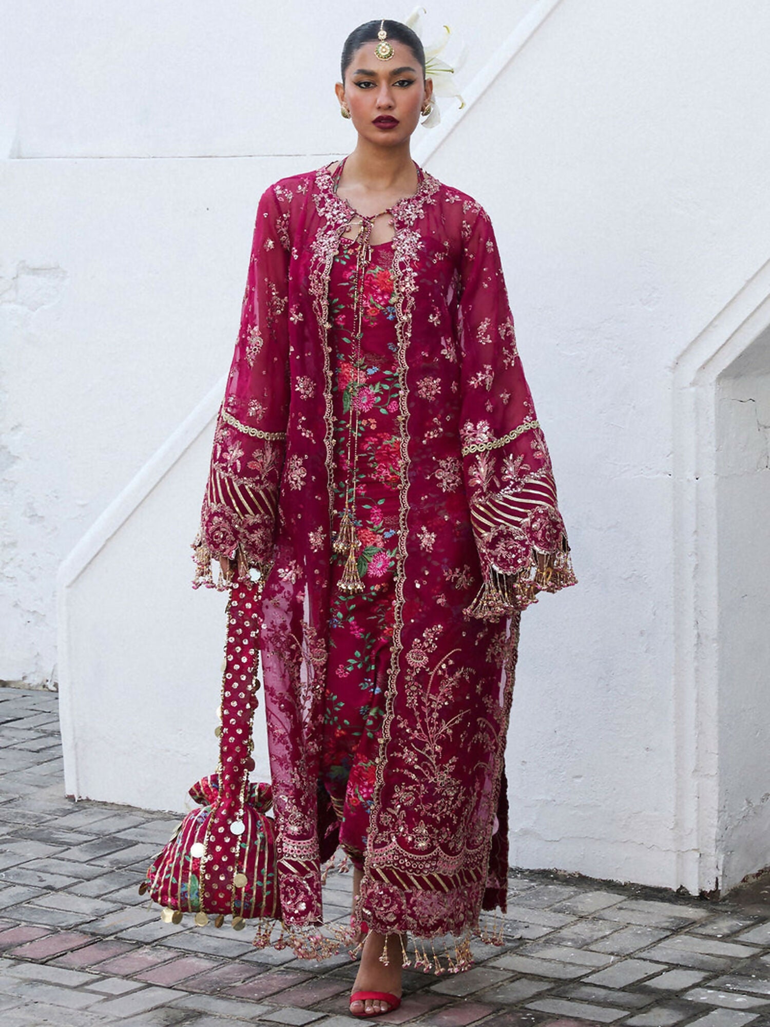 Burgundy unstitched 4-piece suit featuring embroidered organza jacket, printed Thai silk inner shirt, embroidered organza dupatta, and floral printed Korean silk choridar trousers.