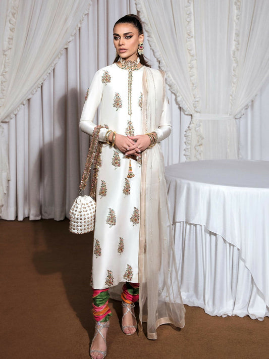 Ivory raw silk stitched 3-piece suit Blanc by HussainRehar featuring an embellished neckline with gold nakshi, sequins, pink crystals, and multicolor bugle beads with tassel details, paired with a multi-colored printed satin chooridar with gotta work and an organza dupatta with multi-head detailing and lappa on all four borders, ideal for festive occasions.